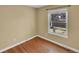 Bedroom with hardwood floors, neutral walls and large window providing natural light at 6417 S Florence Way, Englewood, CO 80111