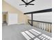 View of bonus room with ceiling fan, open staircase, and vaulted ceilings at 6417 S Florence Way, Englewood, CO 80111