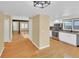 Open floor plan with a view from the kitchen to the living area with hardwood floors at 6417 S Florence Way, Englewood, CO 80111
