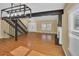 Hardwood floors, fireplace, and stairs give this open concept living room a modern aesthetic at 6417 S Florence Way, Englewood, CO 80111