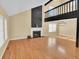 Spacious living room with a fireplace, hardwood floors, and a modern light fixture at 6417 S Florence Way, Englewood, CO 80111
