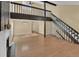 Bright living room with hardwood floors, fireplace, open staircase, and modern light fixture at 6417 S Florence Way, Englewood, CO 80111