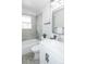 Modern bathroom with a white vanity, bathtub and shower at 710 S Oakland St, Aurora, CO 80012