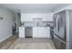 Modern kitchen with white cabinets, stainless steel appliances, and granite countertops at 710 S Oakland St, Aurora, CO 80012