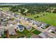 Overhead shot highlights a blue-gray home nestled in a well-kept neighborhood near lush greenery and scattered trees at 965 Peach Leaf Ln, Elizabeth, CO 80107