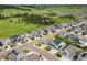 An aerial view showcases a home's location in a neighborhood bordering verdant fields and scattered woodland at 965 Peach Leaf Ln, Elizabeth, CO 80107