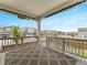 Large back porch features a patterned outdoor rug and neighborhood views at 965 Peach Leaf Ln, Elizabeth, CO 80107