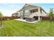 Backyard features a hot tub, lawn, and multi-level porch at 965 Peach Leaf Ln, Elizabeth, CO 80107