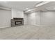 Finished basement showcasing a modern stone fireplace and neutral carpeting at 965 Peach Leaf Ln, Elizabeth, CO 80107