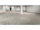 Large open basement area with neutral carpeting and supportive pillars at 965 Peach Leaf Ln, Elizabeth, CO 80107