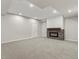 Finished basement with plush carpeting, modern fireplace with stone surround, and bright recessed lighting at 965 Peach Leaf Ln, Elizabeth, CO 80107