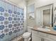 Bathroom features a shower with a patterned curtain and sink with a mirror at 965 Peach Leaf Ln, Elizabeth, CO 80107