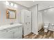 Bathroom featuring a light-colored vanity with wooden mirror and shower behind a partition at 965 Peach Leaf Ln, Elizabeth, CO 80107