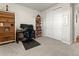 Bright bedroom featuring carpet flooring, desk area, and closet for storage at 965 Peach Leaf Ln, Elizabeth, CO 80107