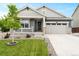 Charming single-Gathering home featuring a landscaped front yard, covered porch, and an attached two-car garage at 965 Peach Leaf Ln, Elizabeth, CO 80107