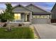 Charming single-Gathering home featuring a landscaped front yard, covered porch, and an attached two-car garage at 965 Peach Leaf Ln, Elizabeth, CO 80107
