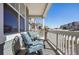 Covered front porch features cushioned chairs and stone supports at 965 Peach Leaf Ln, Elizabeth, CO 80107