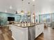 Open-concept kitchen boasts a large island with granite countertops, stainless steel appliances, and pendant lighting at 965 Peach Leaf Ln, Elizabeth, CO 80107