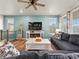 Cozy living room with decorative fireplace, large windows and an open layout at 965 Peach Leaf Ln, Elizabeth, CO 80107