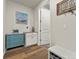 Stylish mudroom with wood-look flooring, blue cabinet and decorative wall art at 965 Peach Leaf Ln, Elizabeth, CO 80107