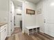 Well-organized mudroom featuring wood floors, bench, and access to laundry room at 965 Peach Leaf Ln, Elizabeth, CO 80107