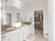Bathroom boasts dual sinks with granite countertops, ample cabinetry, and a walk-in closet for storage and organization at 3231 Riverwood Way, Castle Rock, CO 80109
