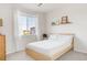 Cozy bedroom with a window offering natural light, neutral walls and carpet, and queen bed with white bedding creating a serene space at 3231 Riverwood Way, Castle Rock, CO 80109
