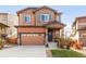 Inviting two-story home with a charming front porch and well-maintained lawn with an attached two car garage at 3231 Riverwood Way, Castle Rock, CO 80109