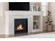 Living room fireplace with decorative tile surround and built-in shelving is the focal point of the neutral living space at 3231 Riverwood Way, Castle Rock, CO 80109