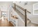 Open hallway featuring a staircase, hardwood floors, and decor at 3231 Riverwood Way, Castle Rock, CO 80109
