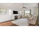 Cozy living room with fireplace, plush rug, ample natural light, and comfortable seating arrangement at 3231 Riverwood Way, Castle Rock, CO 80109