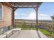 Relaxing outdoor patio with pergola, seating, and views of the surrounding landscape and open space at 3231 Riverwood Way, Castle Rock, CO 80109