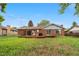 Backyard with brick house, deck, and grassy area at 10330 Melody Dr, Northglenn, CO 80260