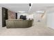 Finished basement with stone accent wall, neutral carpet, and comfortable sofa at 10330 Melody Dr, Northglenn, CO 80260