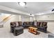 Finished basement with comfortable lounge area, neutral carpet, and convenient wet bar at 10330 Melody Dr, Northglenn, CO 80260