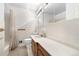 Bright bathroom features modern vanity and shower at 10330 Melody Dr, Northglenn, CO 80260