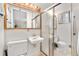 Cozy bathroom showcasing a pedestal sink, toilet, and shower with frosted glass doors at 10330 Melody Dr, Northglenn, CO 80260
