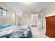 Comfortable bedroom with ensuite bathroom and walk-in closet featuring wood floors at 10330 Melody Dr, Northglenn, CO 80260