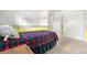 Bright bedroom featuring a colorful accent wall, plush carpet, and a cozy bed with plaid comforter at 10330 Melody Dr, Northglenn, CO 80260