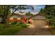 Charming single-story home featuring a brick facade, attached garage, and well-maintained front yard at 10330 Melody Dr, Northglenn, CO 80260