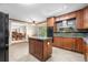 Traditional kitchen with wood cabinets, granite countertops, a center island, and stainless steel appliances at 10330 Melody Dr, Northglenn, CO 80260