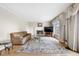 Comfortable living room boasts lots of light and a cozy fireplace at 10330 Melody Dr, Northglenn, CO 80260