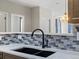 Modern kitchen sink with a black matte faucet and tile backsplash at 4005 S Dillon Way # 102, Aurora, CO 80014