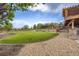 Spacious backyard featuring green lawn, rock landscaping, trees and a wooden fence at 3191 W 151St Ct, Broomfield, CO 80023