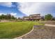 Expansive backyard with lush green grass, mature trees, and a multi-level deck on the home at 3191 W 151St Ct, Broomfield, CO 80023