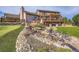 Expansive backyard featuring a multi-level deck, stone water feature, and lush landscaping at 3191 W 151St Ct, Broomfield, CO 80023