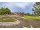 Large backyard with lush green lawn, putting green, deck, and perimeter fencing at 3191 W 151St Ct, Broomfield, CO 80023