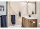 Updated bathroom features a new vanity, modern mirror, and updated shower with a tile surround at 3191 W 151St Ct, Broomfield, CO 80023