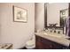 Well-lit powder room with granite countertop, modern faucet, and decorative mirror at 3191 W 151St Ct, Broomfield, CO 80023