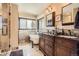 Elegant bathroom with a clawfoot tub, dual vanities, stone tile, and a separate shower offers a spa-like experience at 3191 W 151St Ct, Broomfield, CO 80023